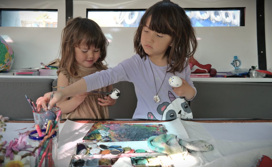 India and Nina painting eggs